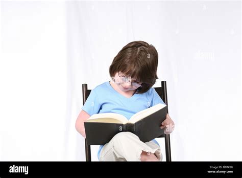 Brunette Girl With Glasses Seated Reading A Book Stock Photo Alamy
