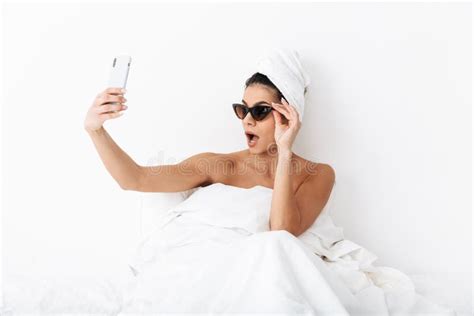 Beautiful Emotional Woman With Towel On Head Lies In Bed Under Blanket