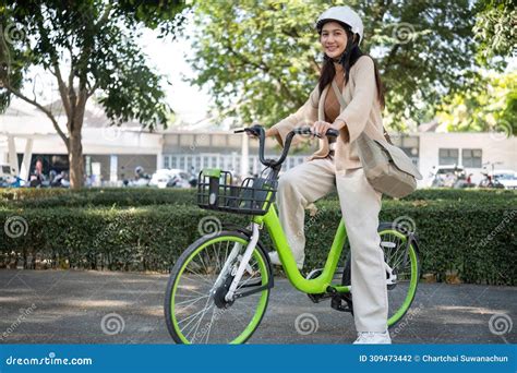 Asian Businesswoman Commute With Her Bicycle In The Streets Happily