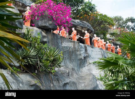 Statues Of Buddhist Monks Making Offerings To Their Lord Buddha At The