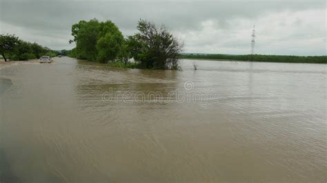 Cars Driving On Flooded Road During A Flood Caused By Heavy Rain