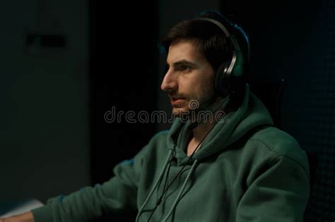 Focused Male Gamer In Headphones Playing Computer Game Stock Image