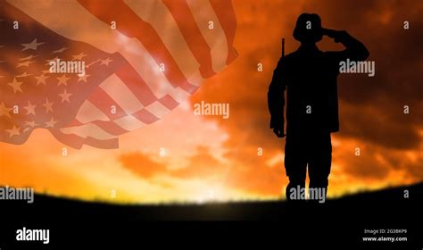 Composition Of Silhouette Of Saluting Soldier Against Sunset Sky With