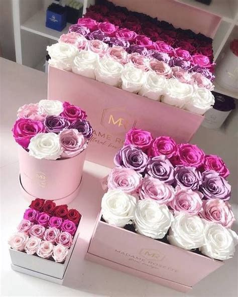 Three Pink And White Boxes With Roses In Them