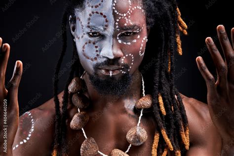 Black Male Model Doing Ritual Isolated Over Black Background Portrait