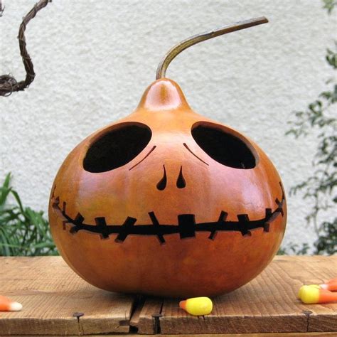 A Carved Pumpkin Sitting On Top Of A Wooden Table