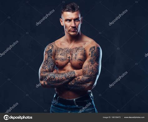 A Muscular Tattooed Man Over Dark Background Stock Photo By Fxquadro