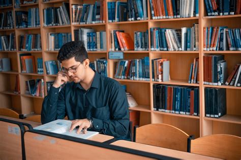 Man Reading a Book Inside the Library · Free Stock Photo