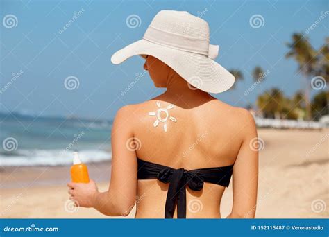 Beautiful Woman In Bikini Applying Sun Cream On Tanned Shoulder Sun