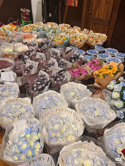 A Table Filled With Lots Of Different Types Of Cakes And Flowers In