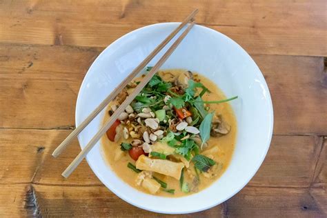 Close Up Of Vietnamese Meal With Chopsticks Vegan Organic Tofu In Red Coconut Curry Sauce With