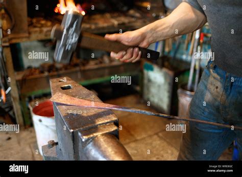 Blacksmith Forging Red Hot Metal With Hammer Stock Photo Alamy