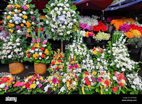 Flowers for sale -bouquets and flowerpots- in a flower stand placed in ...