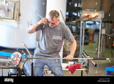 Man Demonstrating How To Blow Glass At The National Glass Centre In