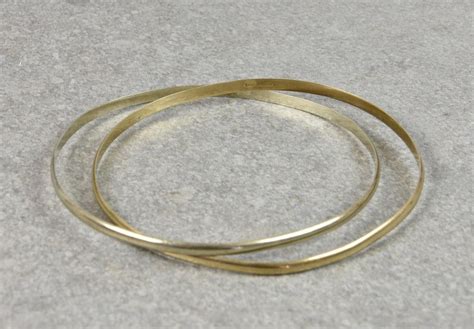 Lot A Pair Of Interlocking 9ct Gold Bangles Hallmarked Sheffield 1977