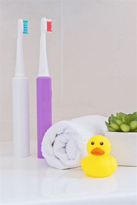 Electric Toothbrushes On Sink In The Bathroom Stock Photo Image Of