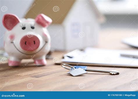 On Table Is Piggy Bank And Document With House Key Stock Photo Image