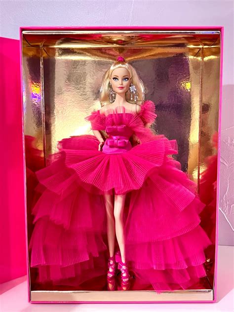 A Barbie Doll In A Pink Dress And High Heeled Shoes Inside A Pink Box