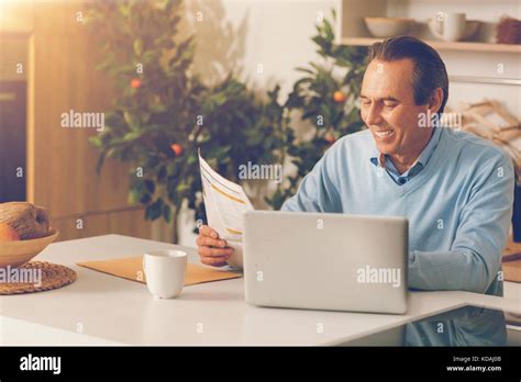 Joyful Mature Man Reading Newspaper In Morning Stock Photo Alamy