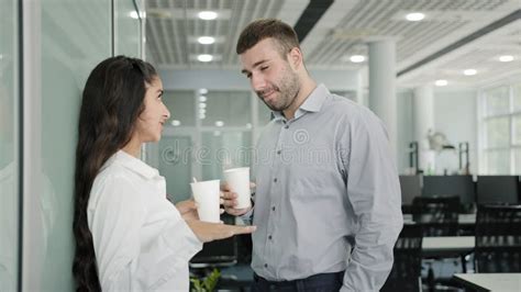 Diverse Colleagues Communicate During Lunch Break In Office Drinking