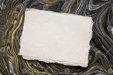 Sheet Of Blank White Khadi Rag Paper Against Marbled Paper Stock Image