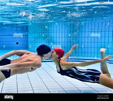 Couple Kissing In Swimming Pool Stock Photo Alamy