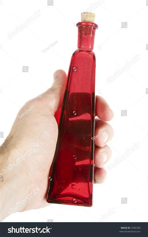 A Male Hand Holding Red Glass Bottle Isolated On White With Clipping