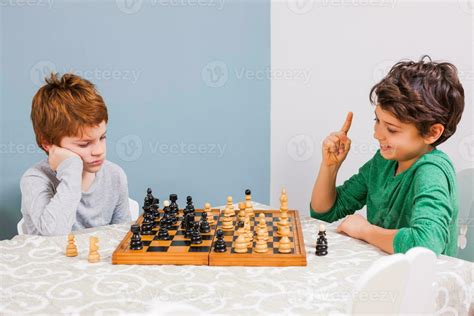 Kids playing chess 23951181 Stock Photo at Vecteezy