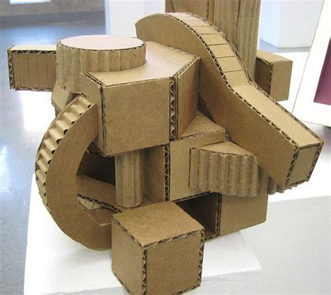 A Sculpture Made Out Of Cardboard Boxes Sitting On Top Of A White Table