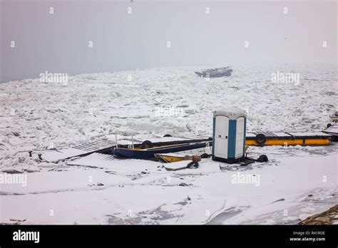 Fishing boat in a frozen river Stock Photo - Alamy