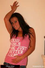 Sweet Brunette Chick Loves Posing Fully Clothed In The Bedroom Photos