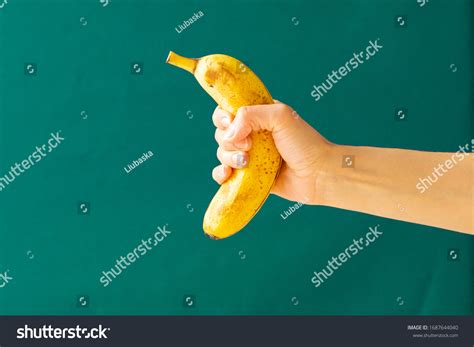 Hand Holding Banana Green Background Concept Stock Photo 1687644040