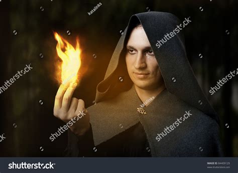 Halloween Concept Powerful Male Witch Or Wizard With Fire In Hands