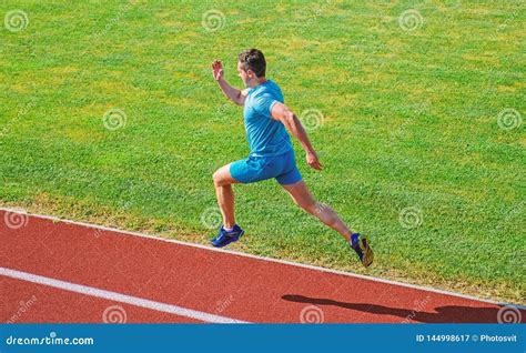 Athlete Run Track Grass Background Sprinter Training At Stadium Track Runner Captured In