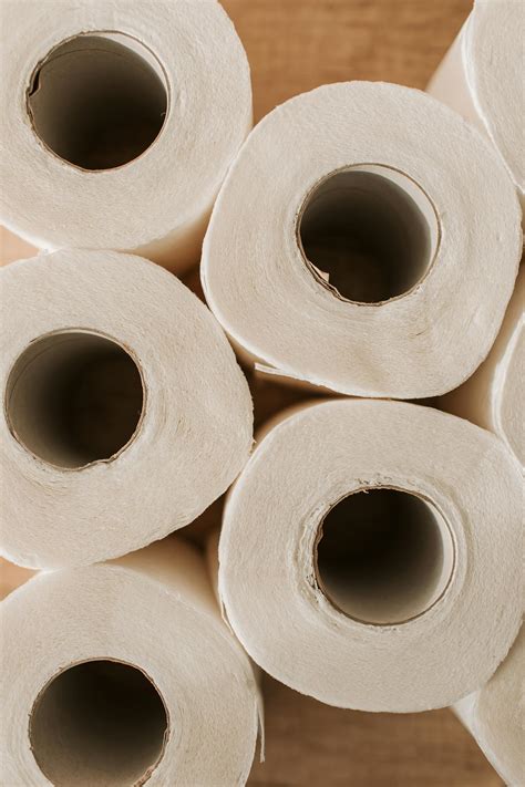 Set Of Toilet Paper On Wooden Background · Free Stock Photo