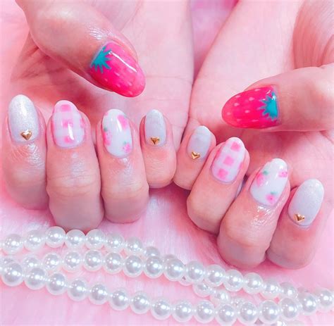 Two Hands With Pink And White Nail Designs On Them