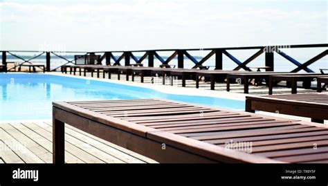 Wooden Sun Loungers By The Pool Near The Sea Relax On A Sun Lounger