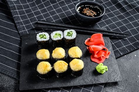 Premium Photo Various Kinds Of Sushi Served On Black Stone Top View