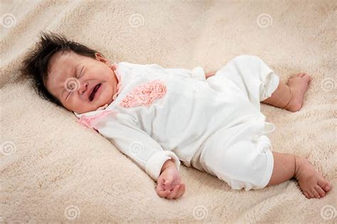 Adorable Asian Newborn Dressed In White Cries With Sleepiness And