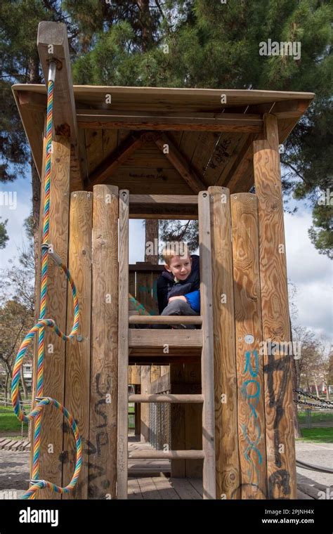 Cute Little Boy Playing Hide And Seek And Hiding In A Wooden Tower At