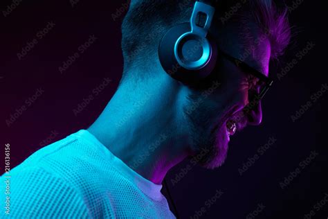 Neon Portrait Of Bearded Smiling Man In Headphones Sunglasses White T