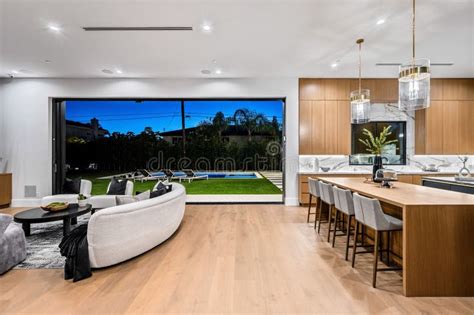 Modern Open Concept Living Room And Kitchen With Backyard Pool View