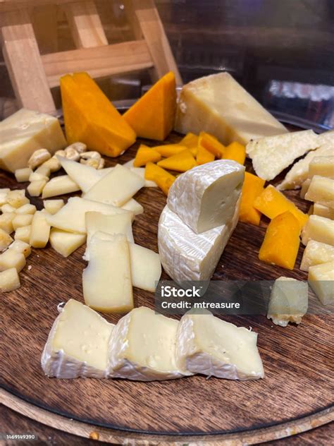 Closeup Image Of Delicatessen Cheese Sampling Display On Wooden Board