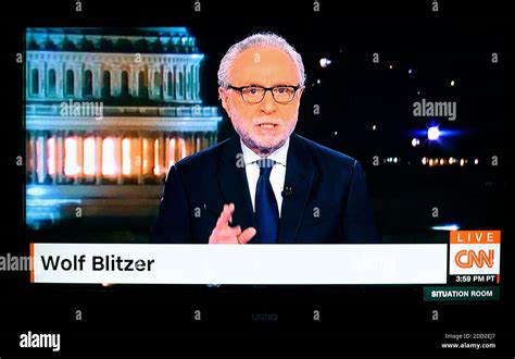 A television screenshot of CNN news anchor Wolf Blitzer delivering the ...