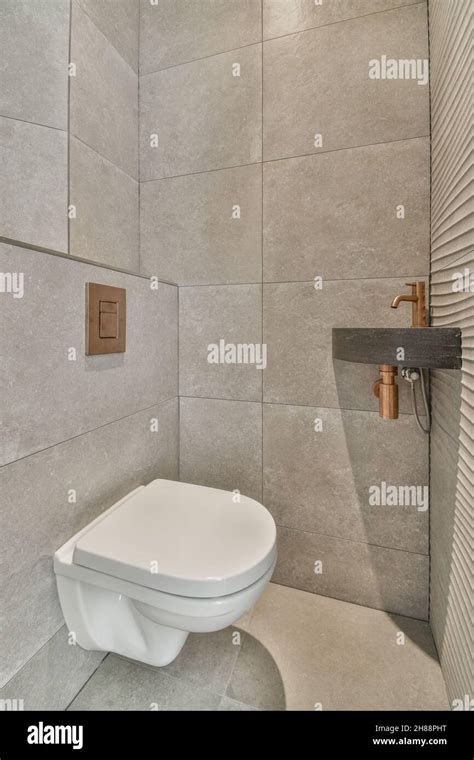Washroom With Wall Hung Toilet And Small Corner Sink Stock Photo Alamy