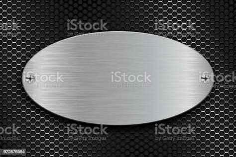 Metal Brushed Oval Plate On Perforated Steel Background Stock