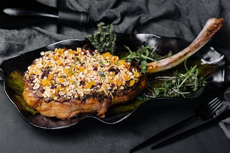 Premium Photo Barbecue Tomahawk Steak On Black Plate