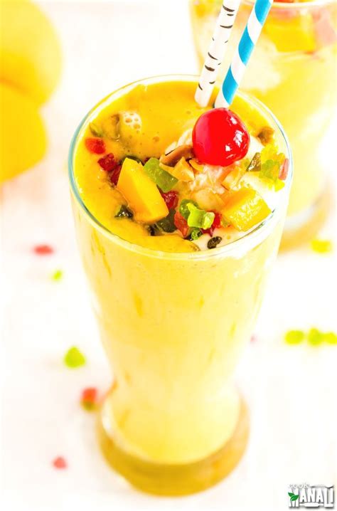 Thick Mango Milkshake Topped With Vanilla Ice Cream Nuts And Tutti