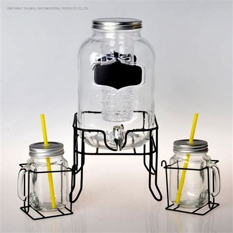 Two Mason Jars With Yellow Straws In Them And One Jar Has A Black Label