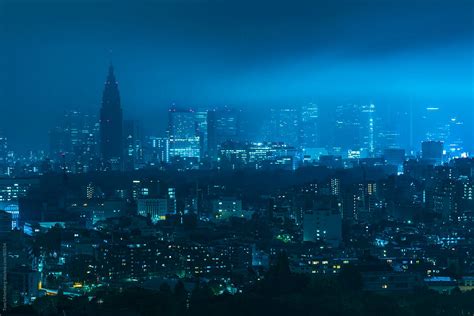 Moonlight Gleaming Through Clouds And Fog Over Shinjuku Skyline In